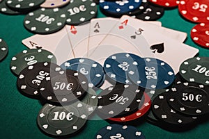 Four of a kind aces poker gaming chips. Winning combination of cards on the table in casino
