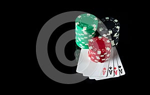 Four of a kind or quads cards and chips in the black background. Winning combination at a poker club or casino. Free advertising