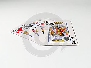 Four kings from a deck of playing cards isolated on a white background. Pik, club, diamond and heart suit