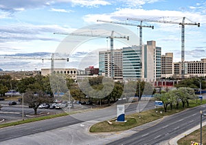 Four large cranes on construction project Southwestern Medical District in Dallas, Texas