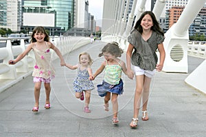 Four little girl group walking in the city