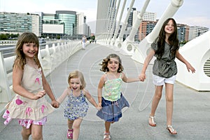 Four little girl group walking in the city