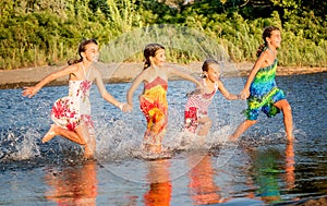 Four little girls having fun in the water in Ada bojana, Montene