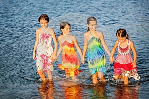 Four little girls having fun in the water on Ada bojana, Montene