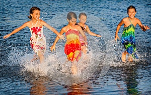 Four little girls having fun in the water in Ada bojana, Montene