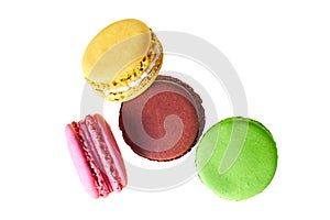 Four macaroons with different colors and varied taste, lemon, almond, chocolate, raspberry, strawberry and mint isolated