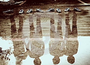 Four man reflection in the water after raining, double exposure