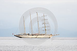 Four masted sailing cruising ship on sea