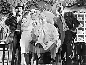 Four men at a barber shop singing photo