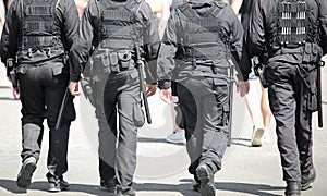 four men with bulletproof vest on the city