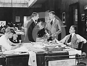 Four men at an office