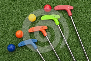 Four Mini Golf Putters and Balls