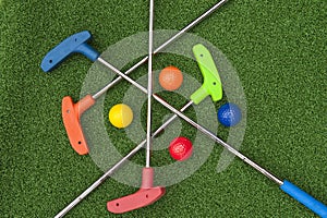 Four Mini Golf Putters and Balls