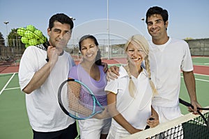 Four Mixed Doubles Tennis Players At Net