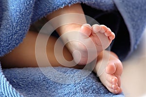 Four month old baby legs in blue towel