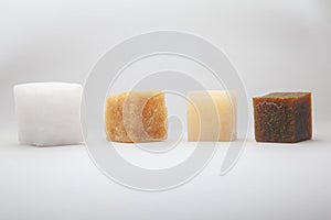 Four multi-colored cubes synthetic rubber samples on a white background shot close up