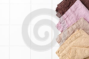 Four multi-colored napkins on cooking stone table with kitchen towel or napkin. Top view with space for your meal or recipe