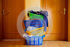 Four multicolored baskets with washed laundry