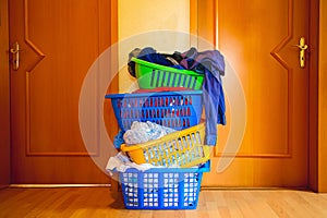 four multicolored baskets with washed laundry