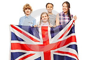 Four multiethnic teenage kids with British flag