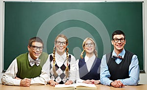 Four nerds in front of blackboard