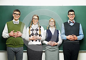 Four nerds in front of blackboard