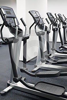 Four new elliptical trainers in modern hall for photo