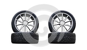 Four new good-looking snow tires isolated on the white background. A set of studded winter car tires. A set of wheels and tyre pac