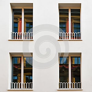 The four new windows with the old house as a reflection