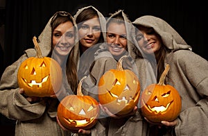 Four nuns holding halloween pumpkins
