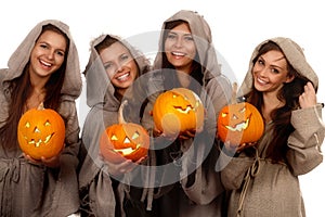 Four nuns holding halloween pumpkins