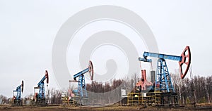 four oil derricks pump oil