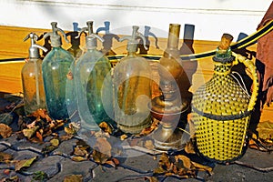 Four old glass siphons, a kerosene lamp and a glass bottle for w