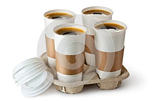 Four opened take-out coffee in holder