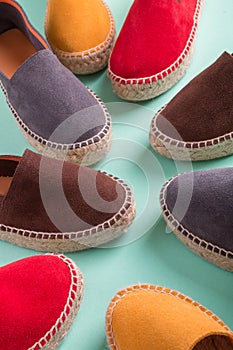 Four pair of espadrilles on mint color background. Close up.