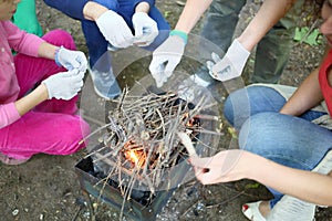 Four pairs of hands in white gloves working