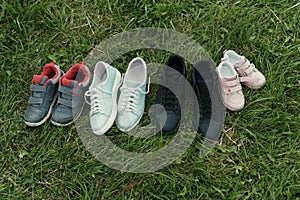 Four pairs of shoes on the grass