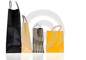 Four paper shopping bags isolated on white background. Shopping bag with blue, brown, and yellow color. Discount sales concept.