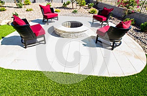 Four Patio Chairs With Cushions Surrounding Rear Patio Round Fire Pit