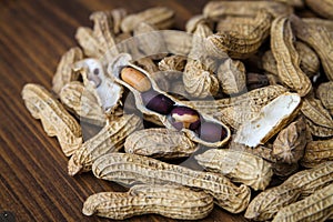 Four peanuts in a shell with purple skins from a Mexican market