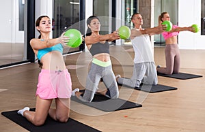 Four people doing exercises with bender balls