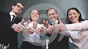 Four people happy showing thumbs