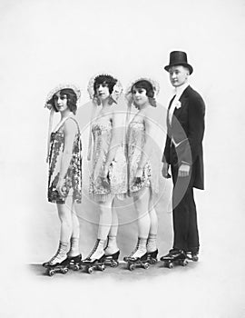 Four people on roller-skates standing in a line