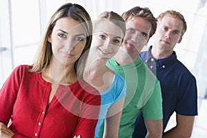 Four people standing in corridor smiling