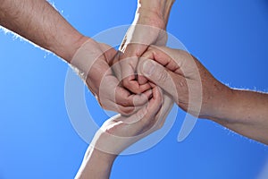 Four persons holding hands