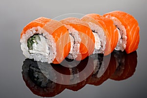 Four philadelphia sushi rol on a glass table