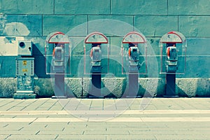 Four phone booths by the wall