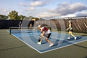 Four Pickleball Players Hitting