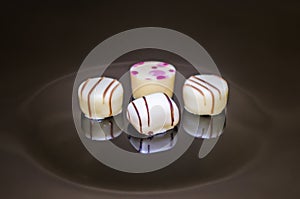 Four piece of chocolate pralines. Number of four strawberry, coconut, vanilla and lemon truffles.