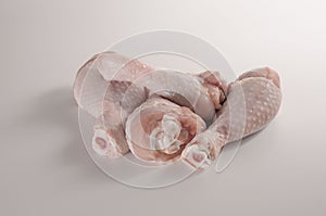Four pieces of raw chicken meat on a light background